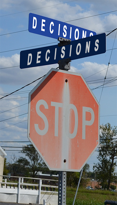 stop sign at the corner of decions and decisions